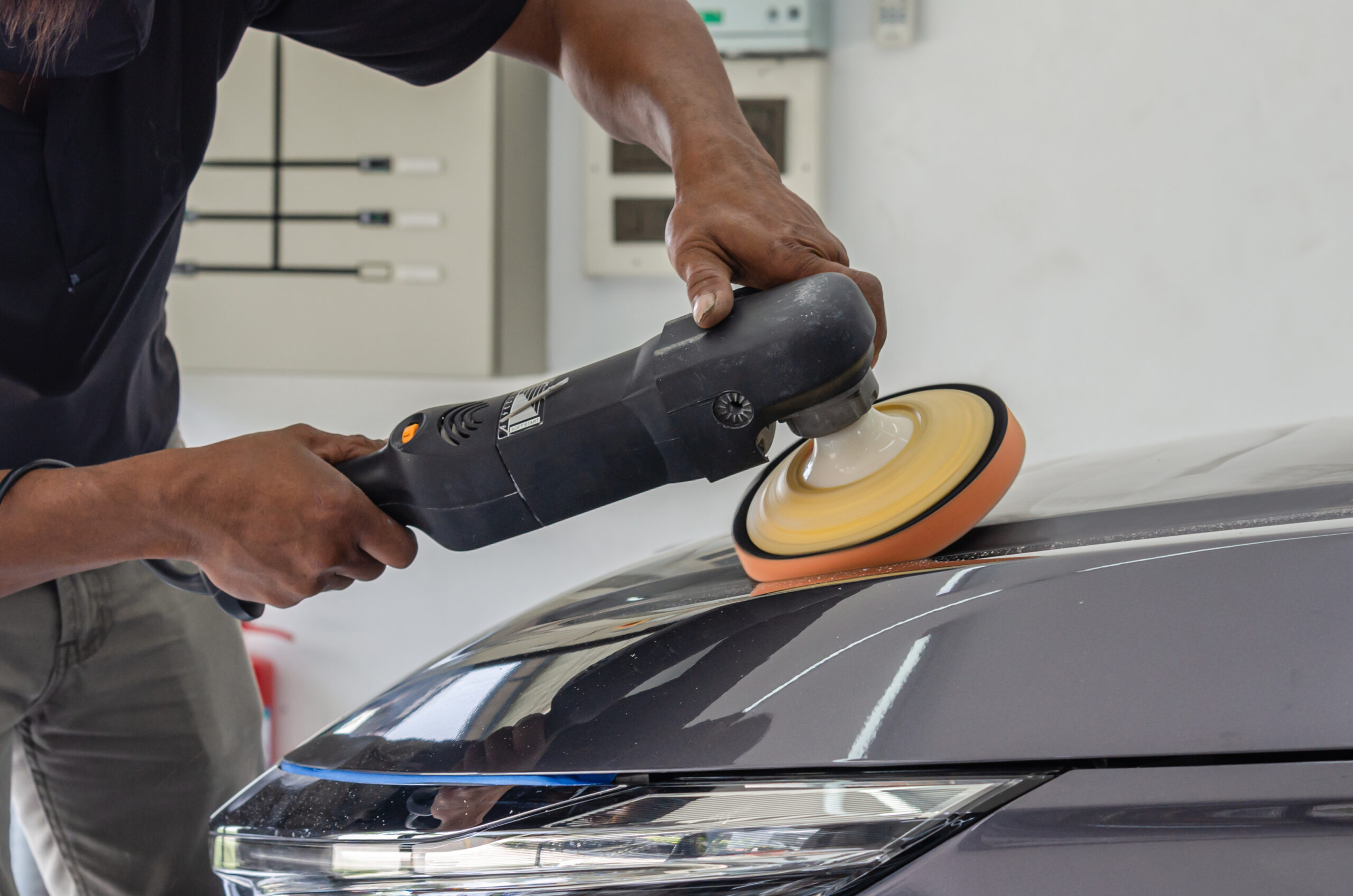 car detailing male mechanic holding car polishin 2025 03 09 18 20 56 utc scaled