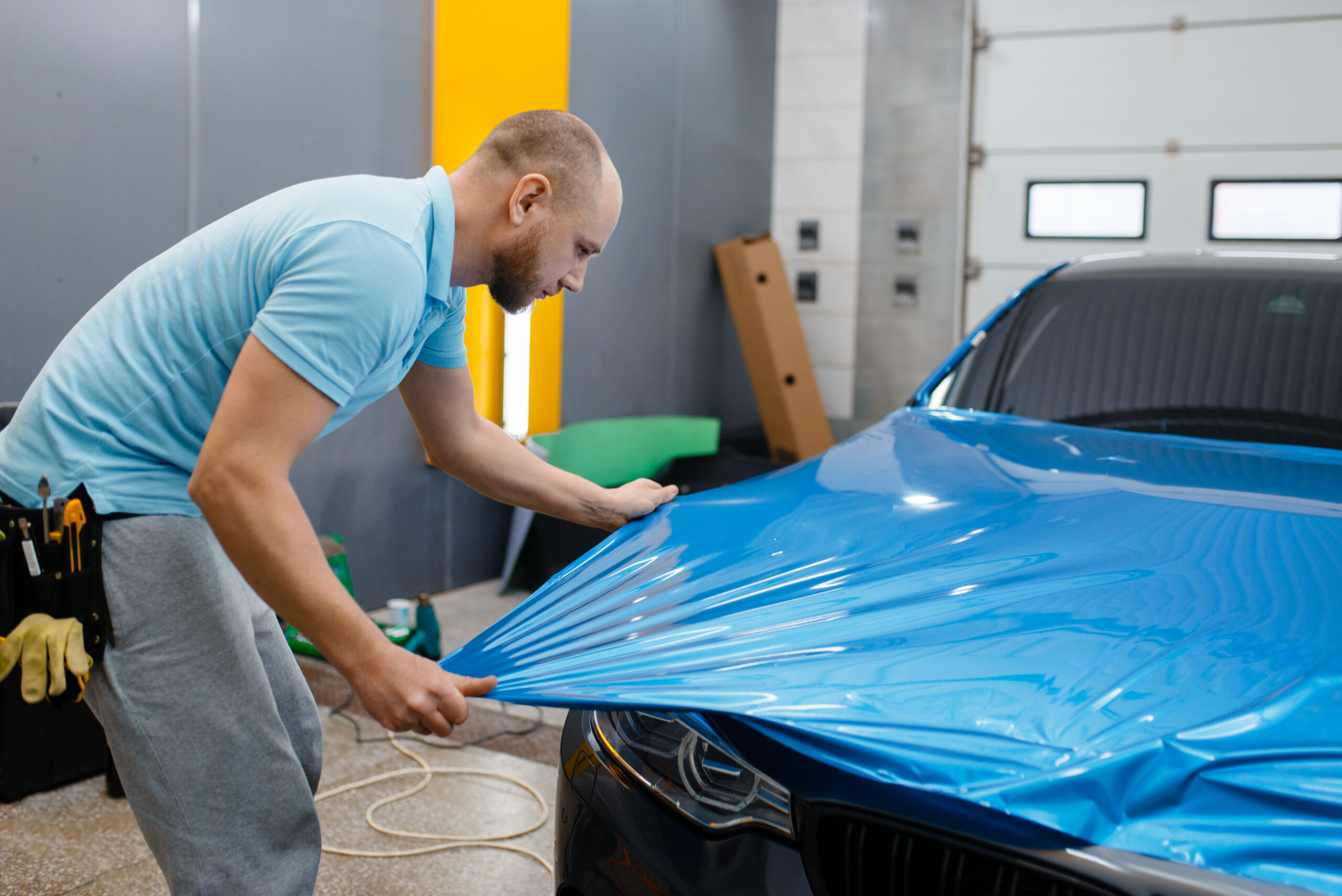 car wrapper puts protective foil or film on hood 2024 11 26 09 45 45 utc scaled